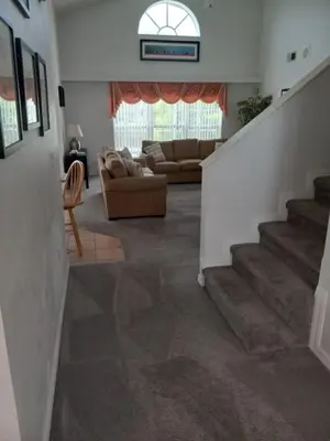 a living room with a couch and a stair case at Fabulous 4 Bed South Facing Lake View Near Disney in Orlando