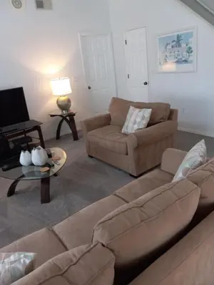 a living room with a couch and a table at Fabulous 4 Bed South Facing Lake View Near Disney in Orlando