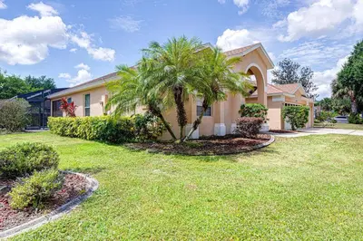 a house with a palm tree in a yard at Spacious 4 Bed South Facing Pool Villa Near Disney in Orlando