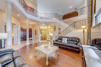 a living room with a couch and a table at Spacious 7 Bedroom Home Close To Disney in Orlando