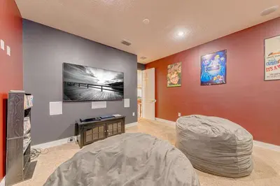 a living room with a wall with a flat screen tv at Spacious 7 Bedroom Home Close To Disney in Orlando