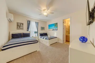a bedroom with two beds and a ceiling fan at Spacious 7 Bedroom Home Close To Disney in Orlando