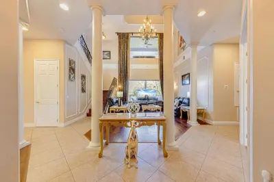 a living room with a table and a couch at Spacious 7 Bedroom Home Close To Disney in Orlando