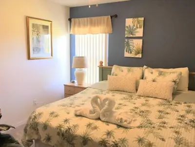a bedroom with a bed with a towel on it at Hidden Waterfront Oasis - 18 Minutes To The Disney in Orlando
