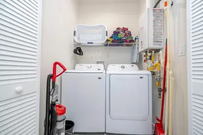 a laundry room with a washer and dryer at Luxury 3BR home with Mario Bros Room Near Disney in Orlando