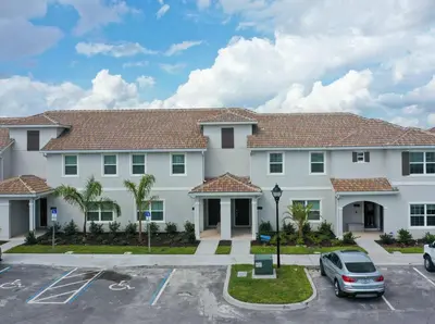 a large white building with a parking lot at Perfect Storey Lake Home for Great Vacation in Kissimmee