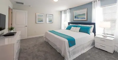 a bedroom with a bed with blue and white at Perfect Storey Lake Home for Great Vacation in Kissimmee