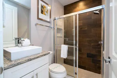 a bathroom with a toilet and a sink and a shower at Modern Chic Home Mickey and Toy Story Rooms in Orlando