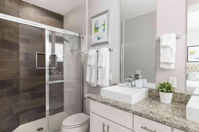 a bathroom with a toilet and a sink and a shower at Chic 4 Bedroom at Summerville Minutes from Disney in Orlando