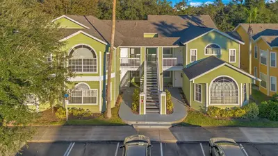 an aerial view of a house with a parking lot at Familiar Retreat with Resort Access Near Disney in Kissimmee