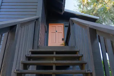 a stairway to a tiny house with a pink door at Historic orlando Casita Joy, DT, Lake Eola, Delaney park, 2 bedrooms 1 bathroom Unit B in Orlando