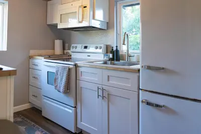 a kitchen with white appliances and a sink at Historic orlando Casita Joy, DT, Lake Eola, Delaney park, 2 bedrooms 1 bathroom Unit B in Orlando
