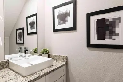 a bathroom with a white sink and a mirror at Stylish 4Bed Townhome at Summerville Near Disney in Orlando