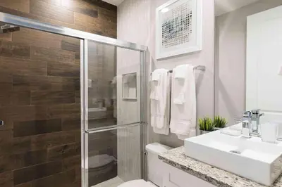 a bathroom with a toilet and a sink and a shower at Stylish 4Bed Townhome at Summerville Near Disney in Orlando