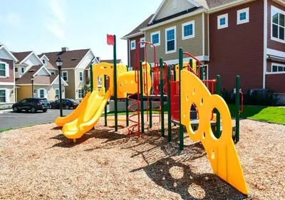 a playground with a yellow slide in a park at Stylish 4Bed Townhome at Summerville Near Disney in Orlando