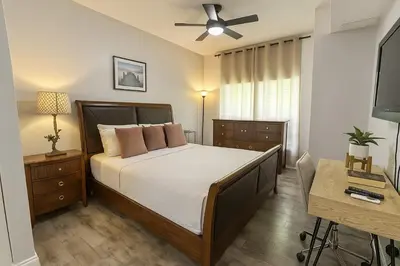 a bedroom with a bed and a ceiling fan at Disney-Area 3BR Townhome | Sleeps 9 | Pool + Gym in Kissimmee