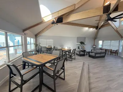 a dining room with tables and chairs and a couch at 2721 North Poinciana #164 in Kissimmee