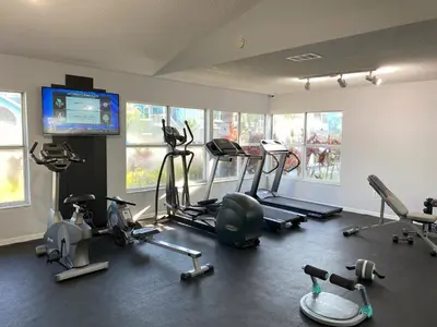 a gym with several exercise bikes and a flat screen tv at 2721 North Poinciana #164 in Kissimmee