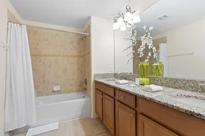 a bathroom with a bath tub and a sink and a bath tub at 5 BD 4 BA Private Pool Paradise Palms (8839 CP) in Kissimmee