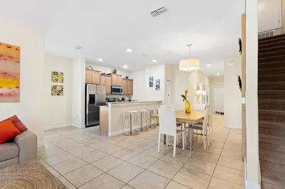 a kitchen and dining room with a table and chairs at 5 BD 4 BA Private Pool Paradise Palms (8839 CP) in Kissimmee