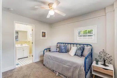 a bedroom with a bed and a ceiling fan at Sanford's Haven, 3 Bedroom, Sleeps 7 in Sanford