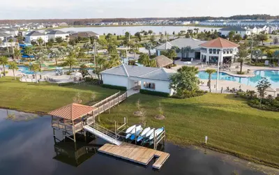 an aerial view of a home with a dock at Chic 2Bed Condo at Storey Lake Mickey Room in Kissimmee