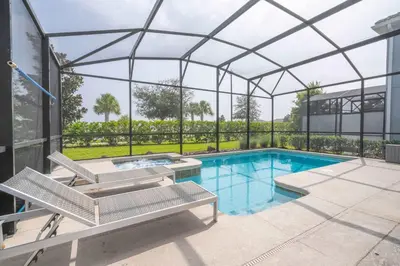 a swimming pool in a glass house with a swimming poolvisor at Home 6Bed , Themed Rooms, Game Room, Storey Lake in Kissimmee