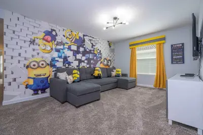 a living room with a couch and a brick wall at Home 6Bed , Themed Rooms, Game Room, Storey Lake in Kissimmee