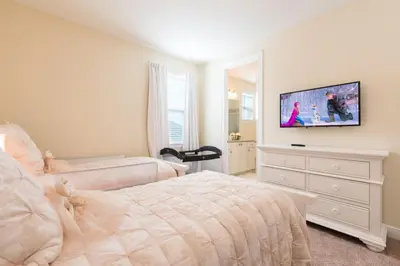 a bedroom with a bed and a flat screen tv at Fabulous Disney Vacation Home in Orlando