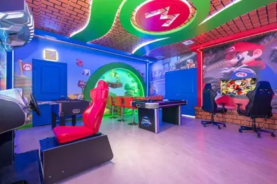 a room with a mario room with a table and chairs at The Ultimate 9bd Disney Getaway Storey Lake in Kissimmee