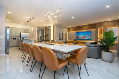 a kitchen and dining room with a white table and chairs at The Best Paradiso Vacation House in Orlando