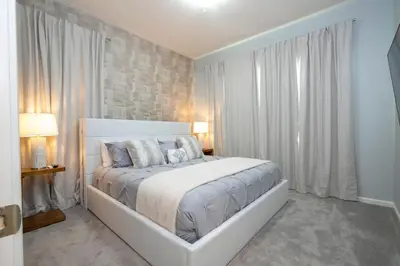 a white bedroom with a large bed in a room at Relax at Paradiso Grande Resort in Orlando