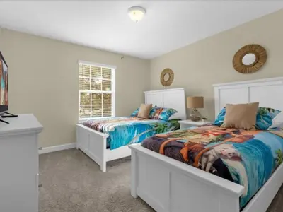 a bedroom with two beds and a window at Comfortable 4 Bedrooms at Storey Lake in Kissimmee