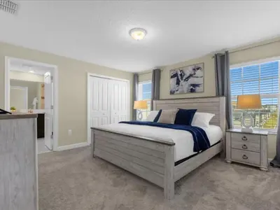 a bedroom with a large bed and a window at Comfortable 4 Bedrooms at Storey Lake in Kissimmee