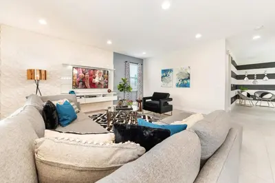 a living room with a couch and a table at Fantastic Disney Vacation W Pool and Movie Theater in Orlando