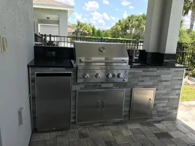 a grill on a patio with a grill at Fantastic Disney Vacation W Pool and Movie Theater in Orlando