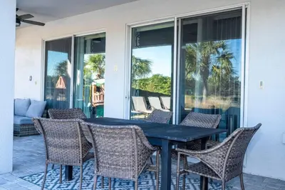 a table and chairs on a patio with a view of the ocean at Fantastic Disney Vacation W Pool and Movie Theater in Orlando
