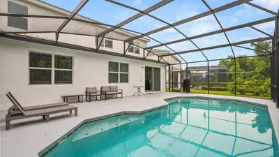 a swimming pool with a glass roof over it at Summer Sale - Beautiful 6BR Home with Private Pool! in Kissimmee