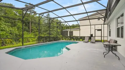 an indoor swimming pool with a table and a tablektop at Summer Sale - Beautiful 6BR Home with Private Pool! in Kissimmee