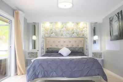 a bedroom with a large bed with a large headboard at Wonderful Villa with swimming pool, near Orlando attractions in Kissimmee