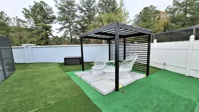 a gazebo with white chairs on a lawn at Wonderful Villa with swimming pool, near Orlando attractions in Kissimmee