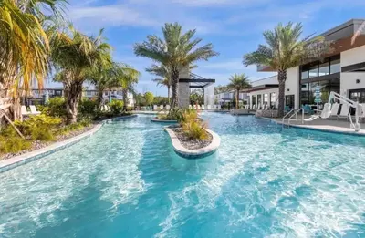 a pool at a resort with palm trees at Lux 5BR Home, Game Room, 4 Suites & Private Pool in Orlando