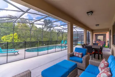 a screened in porch with a view of a pool at 2614 Veranda Palms in Kissimmee