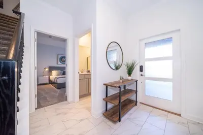 a hallway with a mirror and a room with a bed at 4220AA TOWNHOUSE 4 BEDROOM 3 BATHS + PRIVATE POOL in Kissimmee