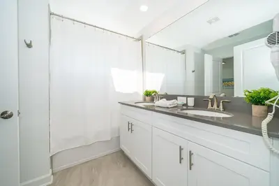a bathroom with a sink and a mirror at 4435LT TOWNHOUSE 4 BEDROOMS & 3 BATHROOMS + POOL in Kissimmee
