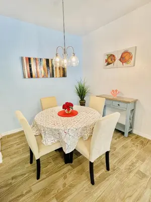 a dining room with a table and chairs at Cozy Condo Minutes Away From Disney in Kissimmee