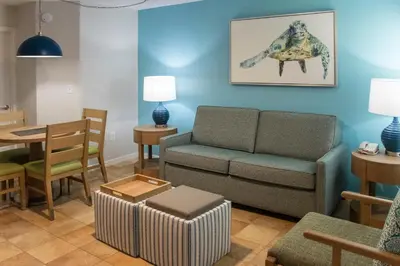 a living room with a couch and a table at Barefoot'n Resort Kissimmee Orlando in Orlando