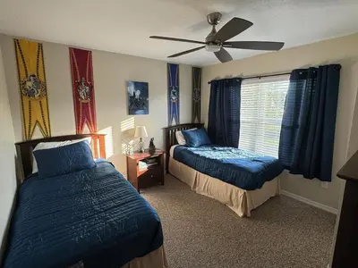 a bedroom with two beds and a ceiling fan at 4 Bedroom 3 Bathroom Villas At SevenDwarfs 12-108 in Kissimmee