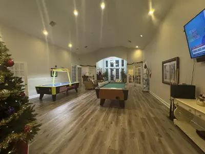 a living room with two pool tables and a christmas tree at 4 Bedroom 3 Bathroom Villas At SevenDwarfs 12-108 in Kissimmee
