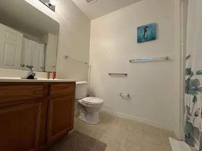 a bathroom with a toilet and a sink at 3 Bedroom 2 Bathroom Villas At SevenDwarfs 21-103 in Kissimmee